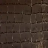 Dark brown embossed leather texture with a consistent crocodile skin pattern of raised rectangular scales and linear grooves, matte finish.